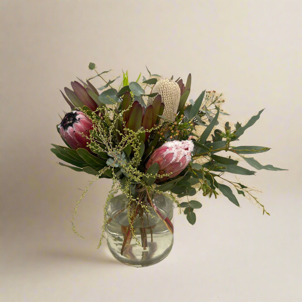 Earthy native flower arrangement with proteas, handcrafted by Adam The Flower Man.