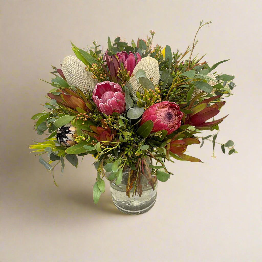Bold winter bouquet with native flowers and proteas from local growers.