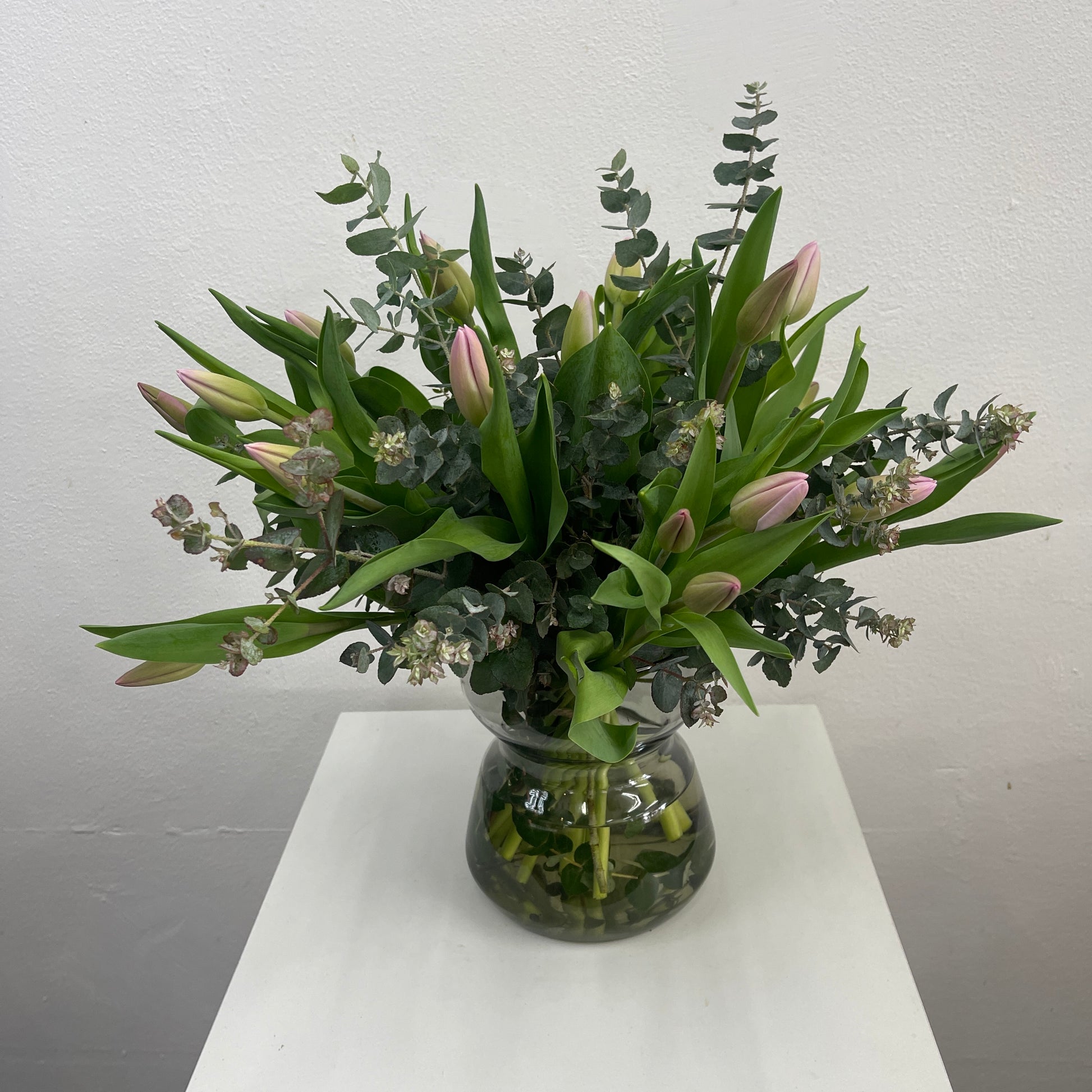 Rounded bouquet of pink tulips with green eucalyptus, made by Adam The Flower Man in Sandringham.