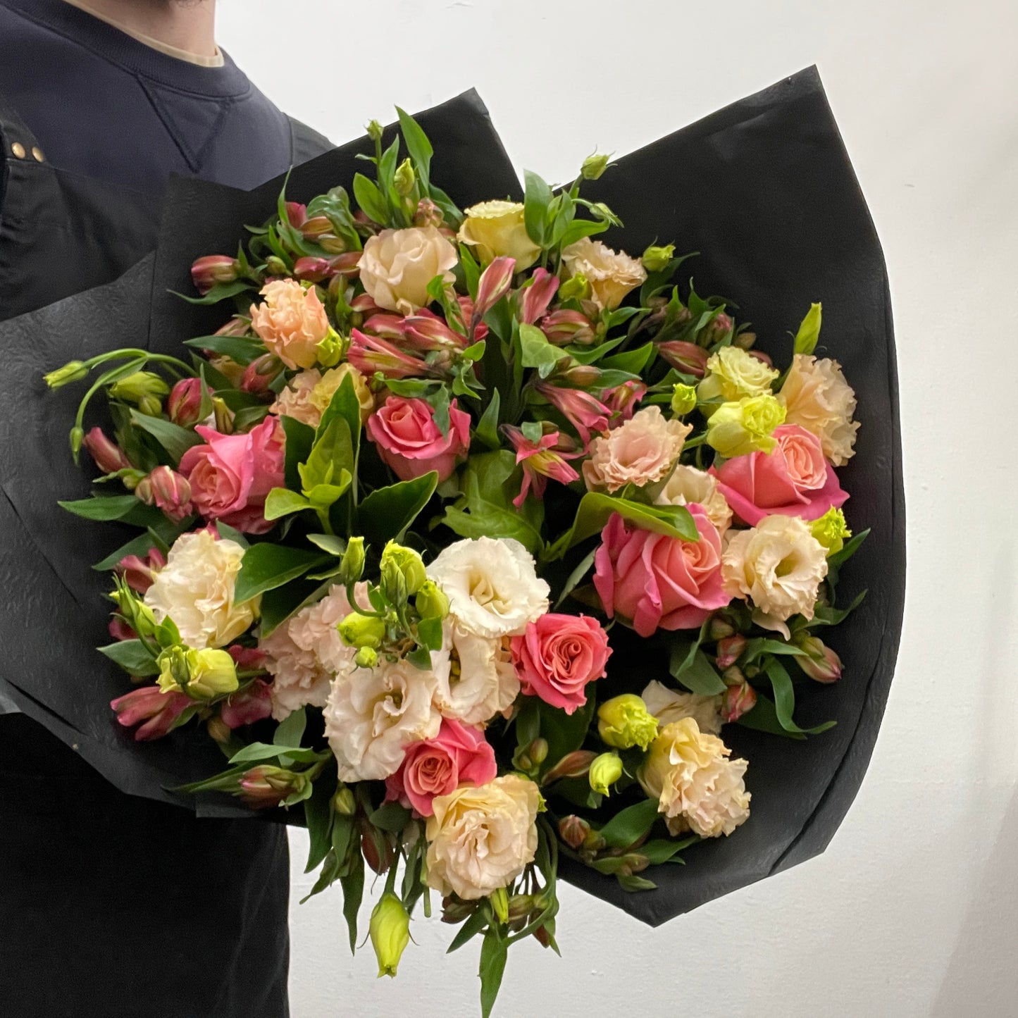 Rounded bouquet featuring pink roses, pink alstroemeria, soft lisianthus, and viburnum foliage in pink and green tones, part of the Spring Limited Collection 2025 by Adam The Flower Man.