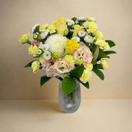 Bright seasonal flower bouquet wrapped in signature paper and ribbon, featuring fresh summer blooms.