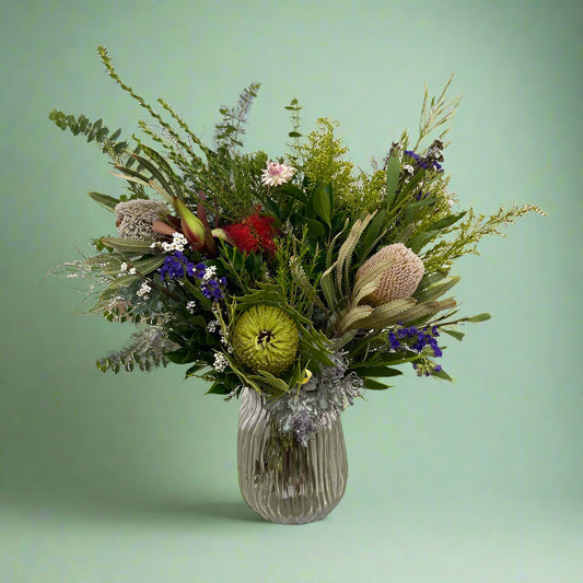 Australian native flower bouquet wrapped in signature paper and ribbon, showcasing fresh seasonal blooms.