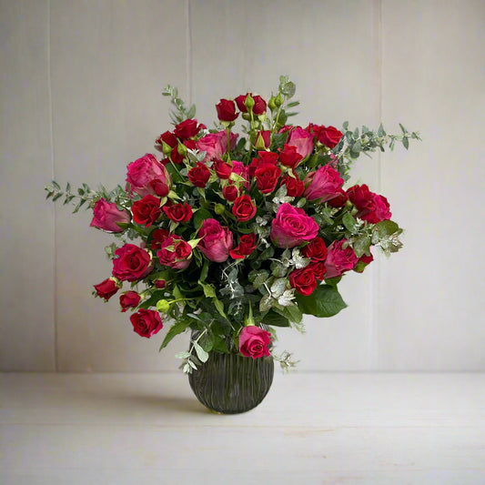 Autumn Bouquet No. 07 with hot pink roses, red spray roses, and eucalyptus made in Sandringham