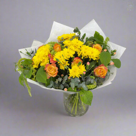 Winter Star bright yellow, orange, and green flower bouquet handmade by Sandringham florist.
