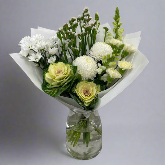 Large white-toned flower bouquet with seasonal blooms, perfect for sympathy or weddings, available for same-day Melbourne delivery.