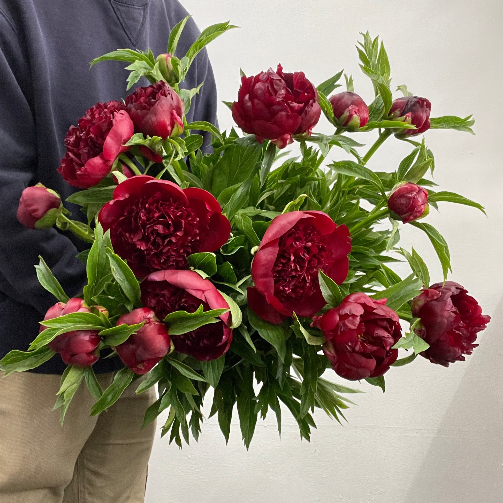 Spiral bouquet of deep red peonies featuring three bunches, made by Adam The Flower Man in Sandringham.