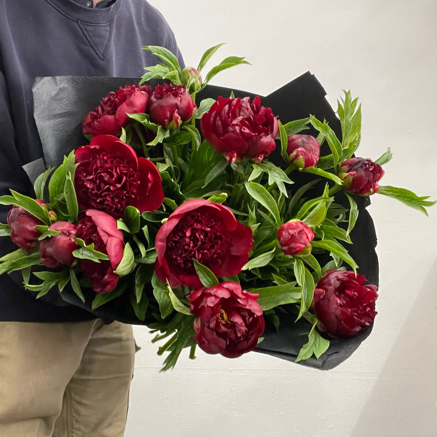 Spiral bouquet of deep red peonies featuring three bunches, made by Adam The Flower Man in Sandringham.