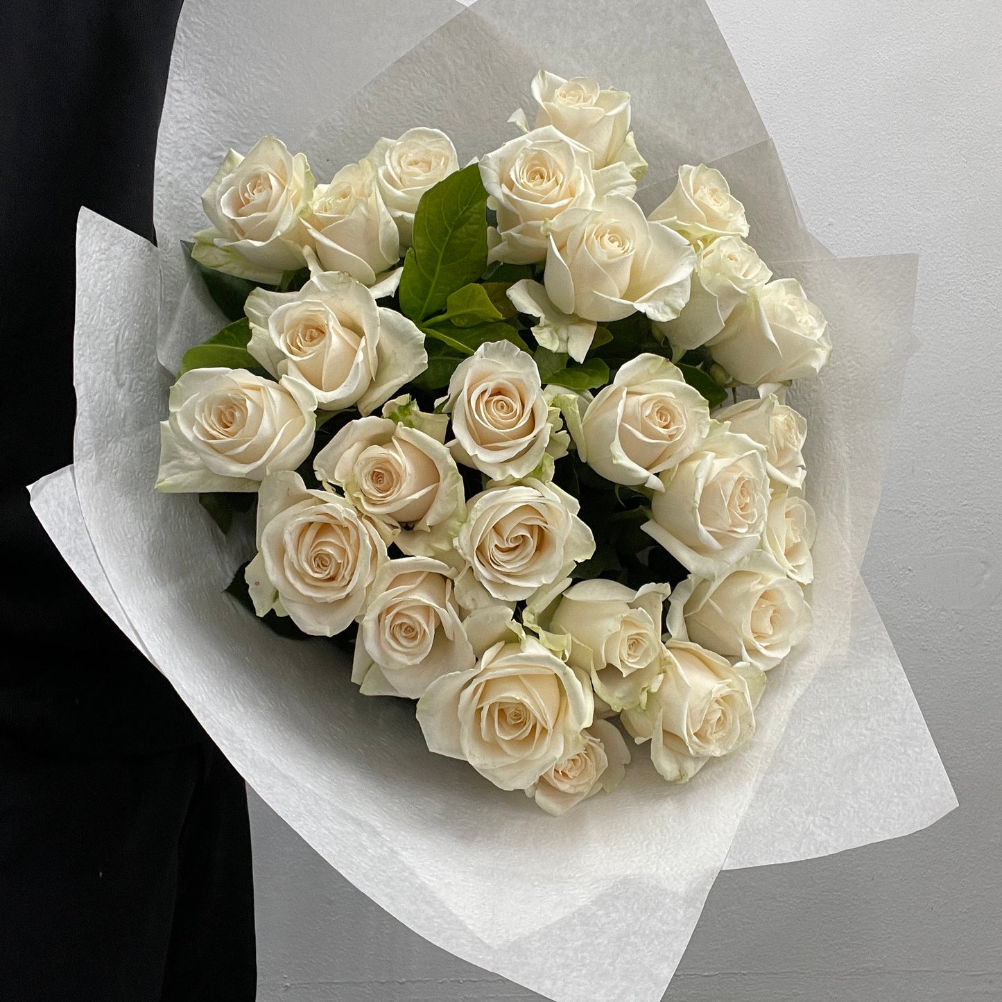 Rounded bouquet featuring white and cream roses with green viburnum foliage, part of the Spring Limited Collection 2025 by Adam The Flower Man.