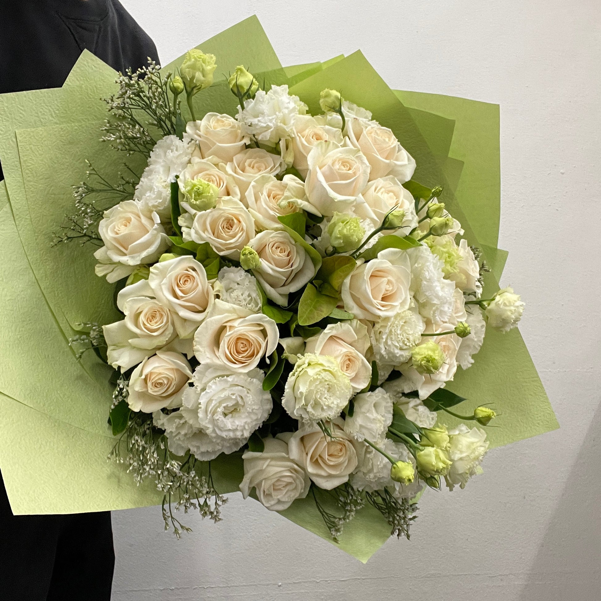 Rounded bouquet featuring Ecuador roses, white lisianthus, misty blooms, and viburnum foliage in white and green tones, part of the Spring Limited Collection 2025 by Adam The Flower Man.