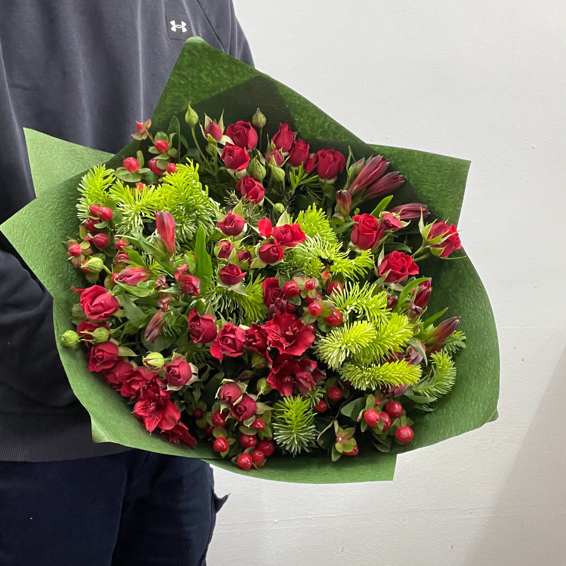 Christmas No. 9 bouquet with red spray roses and festive greenery