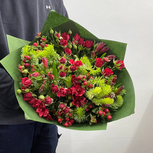 Christmas No. 9 bouquet with red spray roses and festive greenery