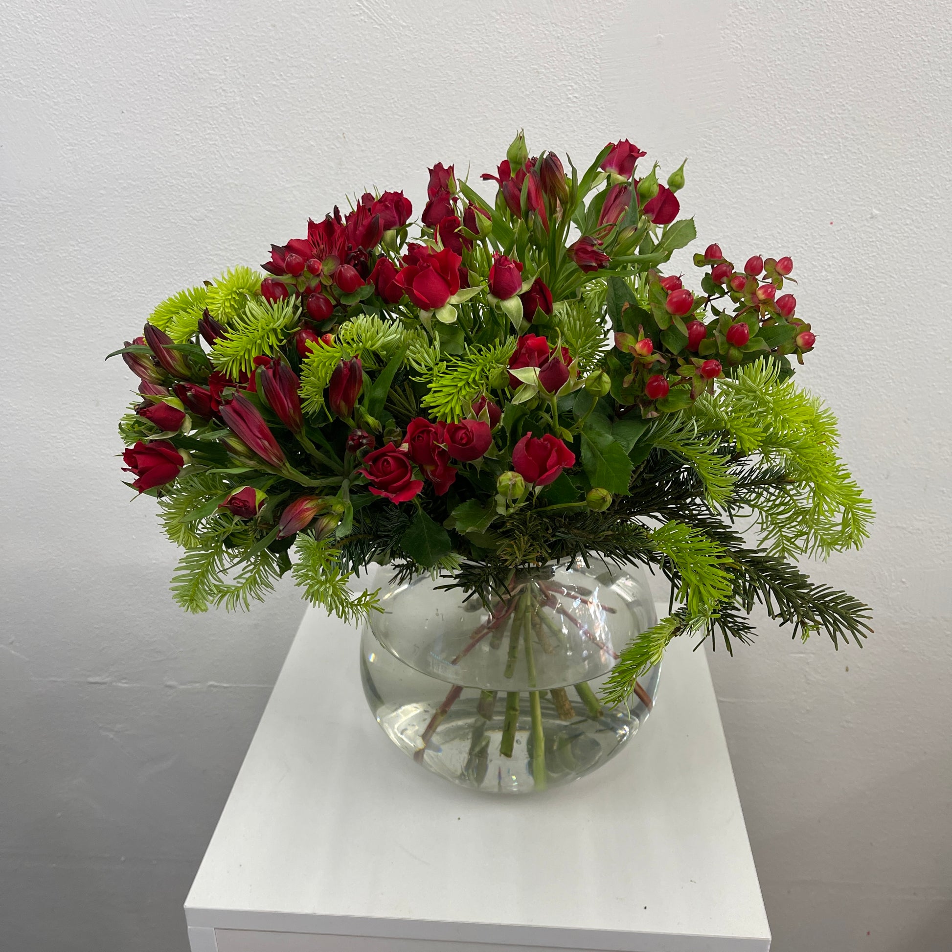 Luxury Christmas flower arrangement with roses, alstroemeria and berries