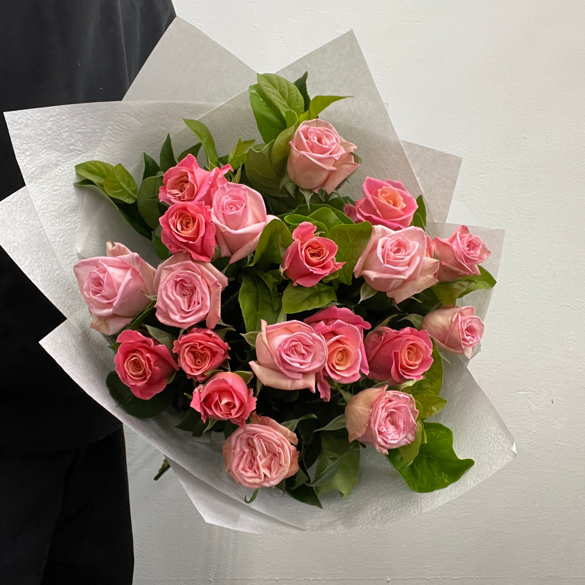 Rounded bouquet featuring long-stemmed pink roses and viburnum foliage in pink and green tones, part of the Spring Limited Collection 2025 by Adam The Flower Man.